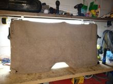 This is the backside view of the upper part of the back seat. The cover, front and back, is one piece. It has plastic, interconnecting locks that hold the pieces together. Simply unhook them and side the whole cover off. Inside you will find a foam piece in front and a hard plastic piece supporting the foam. There are some hook and loop connectors hold things together. Undo the foam and set it aside for now.