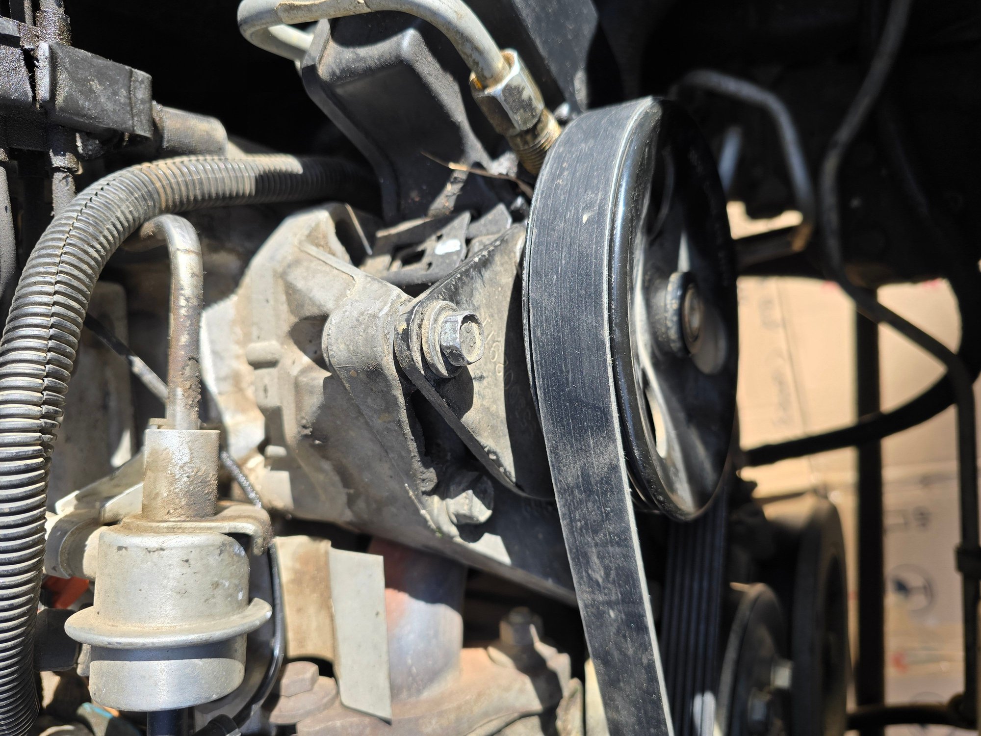 [front view] bolt (1) at top of ps pump configuration, loosened 