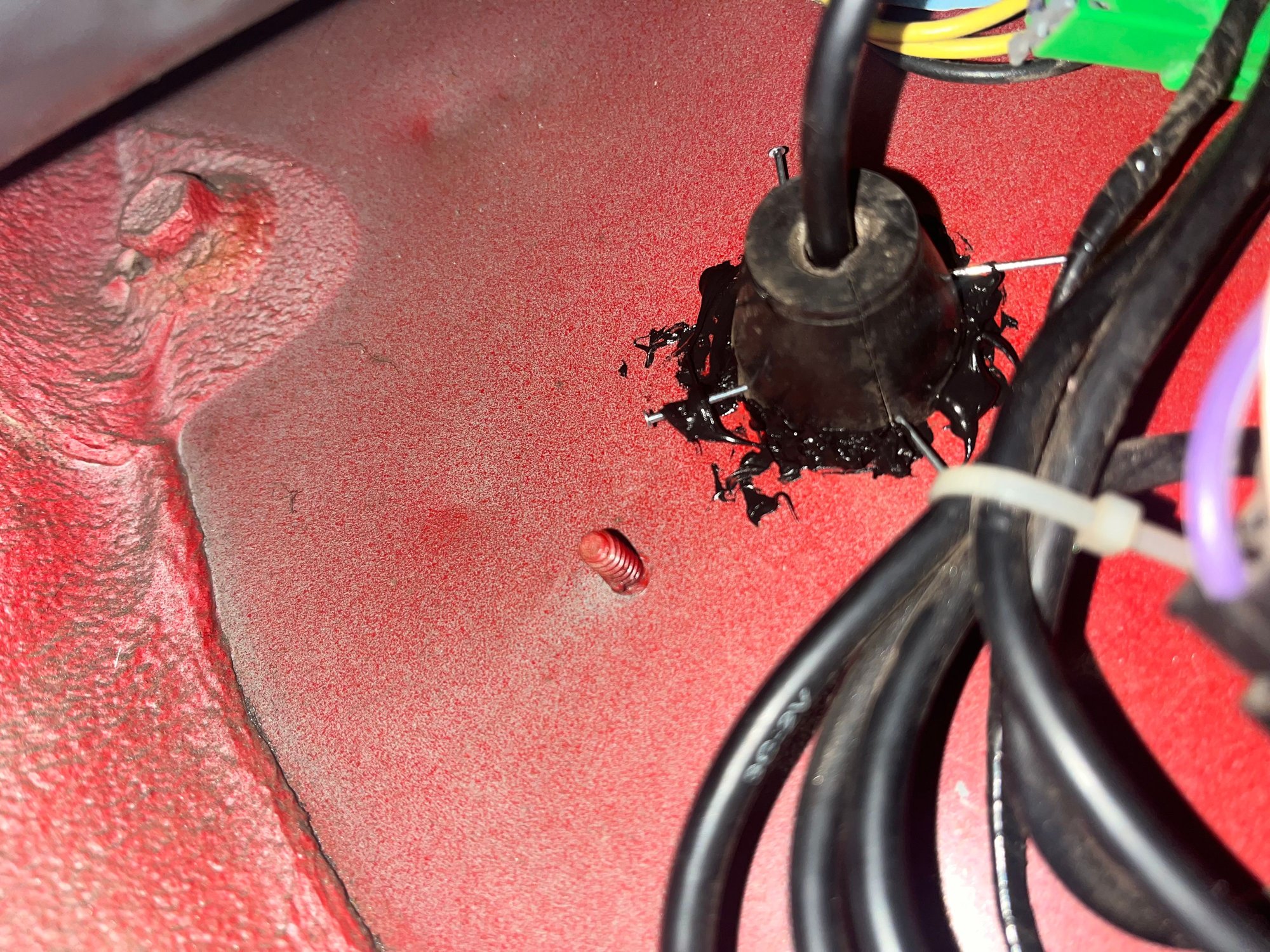 This is behind the passenger kick panel, I sealed around the edge of the rubber plug, but water is still coming in through the hole where the cord is.