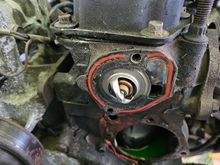 Thermostat gasket and water pump gasket prior to cleaning.