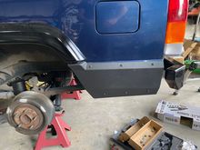 Rough country body armor will cover the factory holes and transition the flares where factory bumper caps were not used