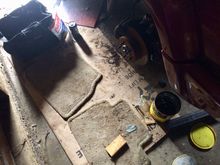 My workspace; a layer of cardboard, then floor mats. Bag of tools, Pepsi and sunflower seeds.