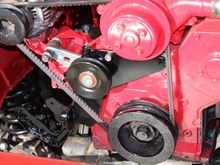 Here is the mounting bracket on the motor,
As far as the idler pulley,, I just picked one from a NAPA book that looked like it would work and started in on some "eyeball engineering". I used a pivot point that was beefy and existing on the Alternator bracket.
For the upper two mounting holes along the top edge of the bracket I had to tap and thread the block,,(If you are wondering,,only one of the two bolts, allen head, is in one of the two the holes for this pic).