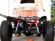 I went with a spring over axle setup and made my own custom shock mounts to replace the whimpy stock setup. They now have 12" of travel and I can lift a tire 15" before the other starts to leave the ground