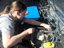 the girl changing out the injectors to 4 hole ones.
