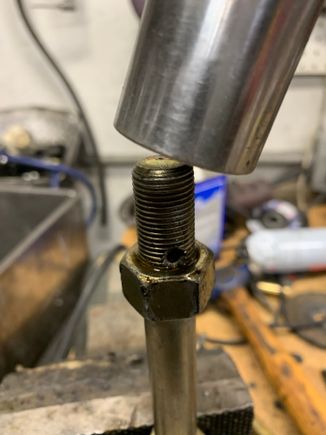 Next put the bolt in the vise again, use some lube and run the nut up and down several times to clean up the threads.