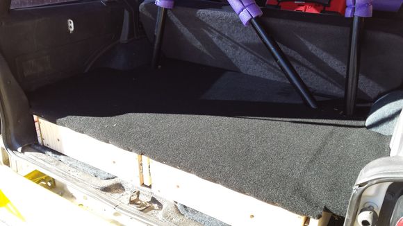A roll of automotive carpet from Autozone covers the deck. I also added some sheeting between the rear seat and the C-pillar on the cage. The drawers don't extend that far, so I have more storage for things that don't get used that much (jack, chocks, etc). Only accessible by pulling the seat back forward.