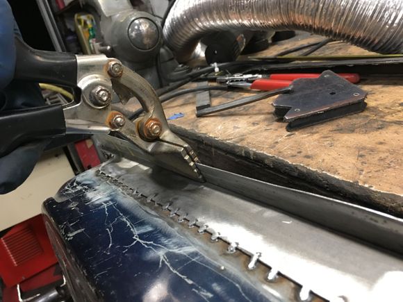 Cleaned up the welds, then started bending the lip over.