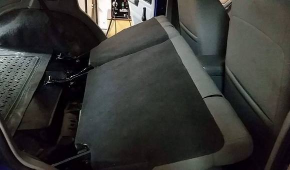 Folds almost flat. Could be folded flat if you wanted to remove the cross braces the factory seat sits on.