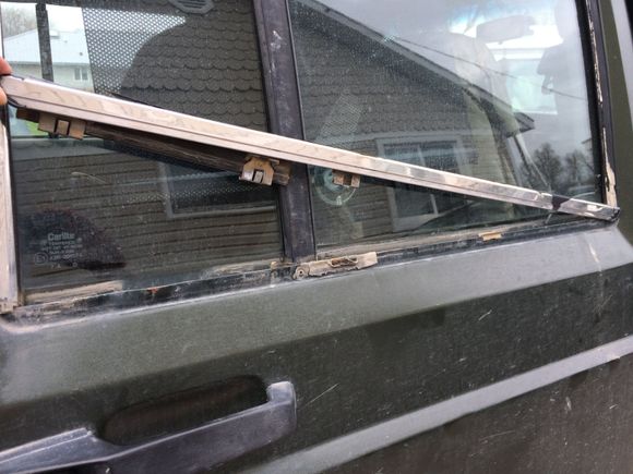 The window trim will come up.  The clips on the bottom trim piece may come up with it, the seal, or stay on the door.