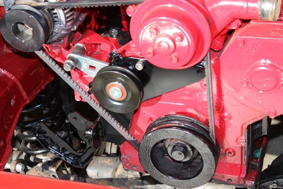 Here is the mounting bracket on the motor,
As far as the idler pulley,, I just picked one from a NAPA book that looked like it would work and started in on some "eyeball engineering". I used a pivot point that was beefy and existing on the Alternator bracket.
For the upper two mounting holes along the top edge of the bracket I had to tap and thread the block,,(If you are wondering,,only one of the two bolts, allen head, is in one of the two the holes for this pic).