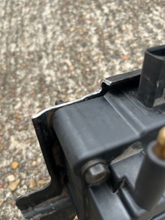 Lower corner trimmed to clear camshaft position sensor