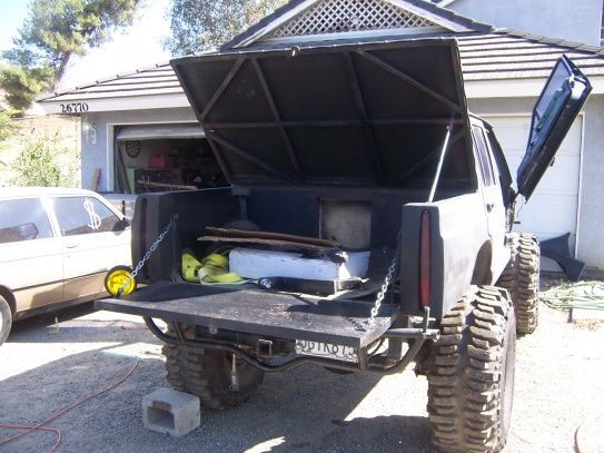 tail gate comes down and top goes up