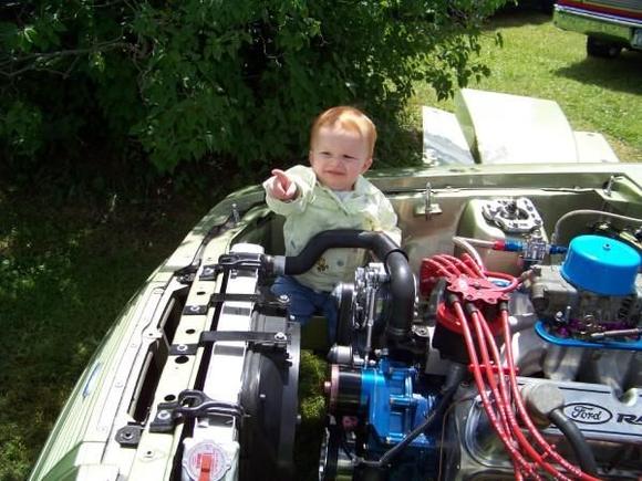 My daughter hangin' out in the engine bay.