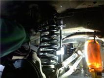 putting it into place in the spring bucket on the axle