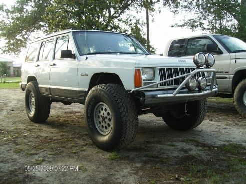 front view with 35's on stock rims and light bar