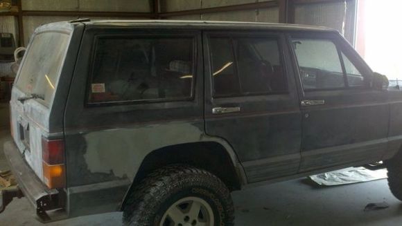 doin alittle bondo work from when i cut the fenders, the body warped alittle after welding in a 1/4 inch round bar
