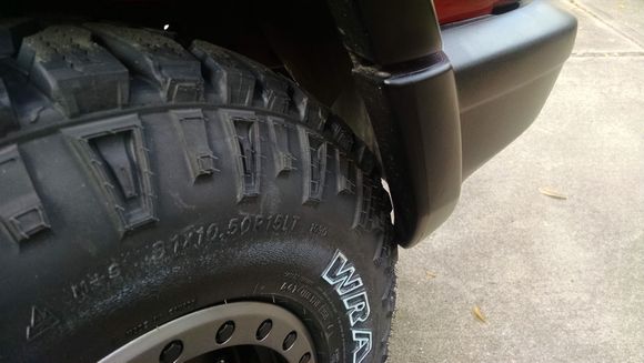 Passenger side front wheel front fender well