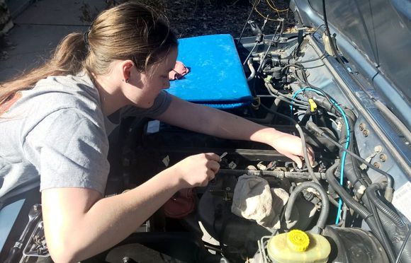 the girl changing out the injectors to 4 hole ones.