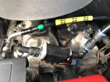 Up under the hood , I routed the new lines up to the fuel pie on the fuel rail and connected the fitting, then the vapour line , the instructions tell you to cut the old line an use the supplied coupler in the hose , that piece with the blue rings.