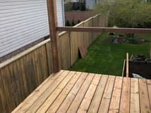 Here’s a shot of our fence same brown wood pressure treated. 