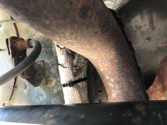 This is over the rear axle and exhaust pipe, insulation sleeve and ty wraps