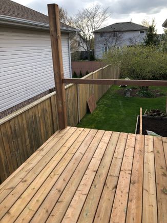 Here’s a shot of our fence same brown wood pressure treated. 