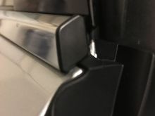 This is how the trim piece looks fully pressed in.  Peel the upper strip of tape's backing film away from the piece and slowly press the trim piece against the door. Make sure it's snugly and securely in the channel before you press down on the tape.  It should look like this.