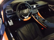 Steering wheel also with orange and blue stitching. 