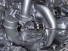 I can’t see anything in your photo of the stock engine. Looks like there’s stuff covering a majority of the stock turbo. the picture angle is different too. Maybe these photos will help us further determine