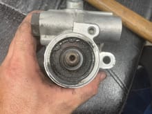 Pulley removed . 17mm nut. Couple taps with a ball peen hammer on the nut. Looks to me like the internal seal is bad and this is where the junk is coming from. It’s blowing out the shaft and past the bearing and it’s seal. 
