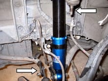 note arrow at bottom torsion bar disconnected to get bottom shock bolt out and top joint disconnected from steering knuckle.