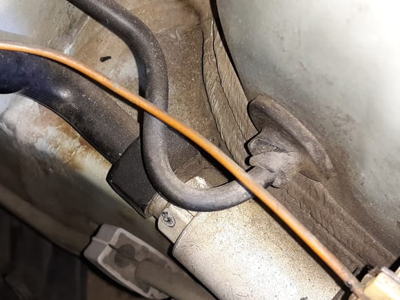 Split brake line through hole rubber grommet at engine side of fender well.
No doubt engine exhaust heat contributed to its demise.
