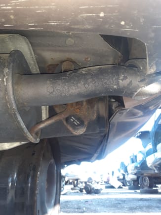 1998 Lexus in pick and pull yard depicting rear muffler -  lower bumper lip area..
At highway speeds, a fair amount of turbulence and drag which the LS430 rectified with a cover plate.