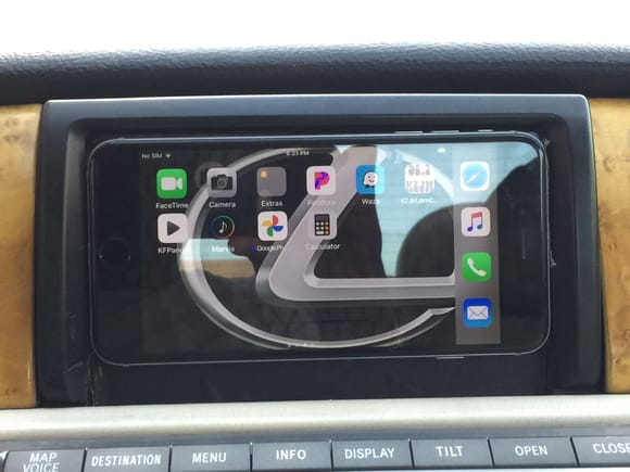 I put a spare iPhone 6 Plus in the space in front of the original navigation screen ( fits snug)