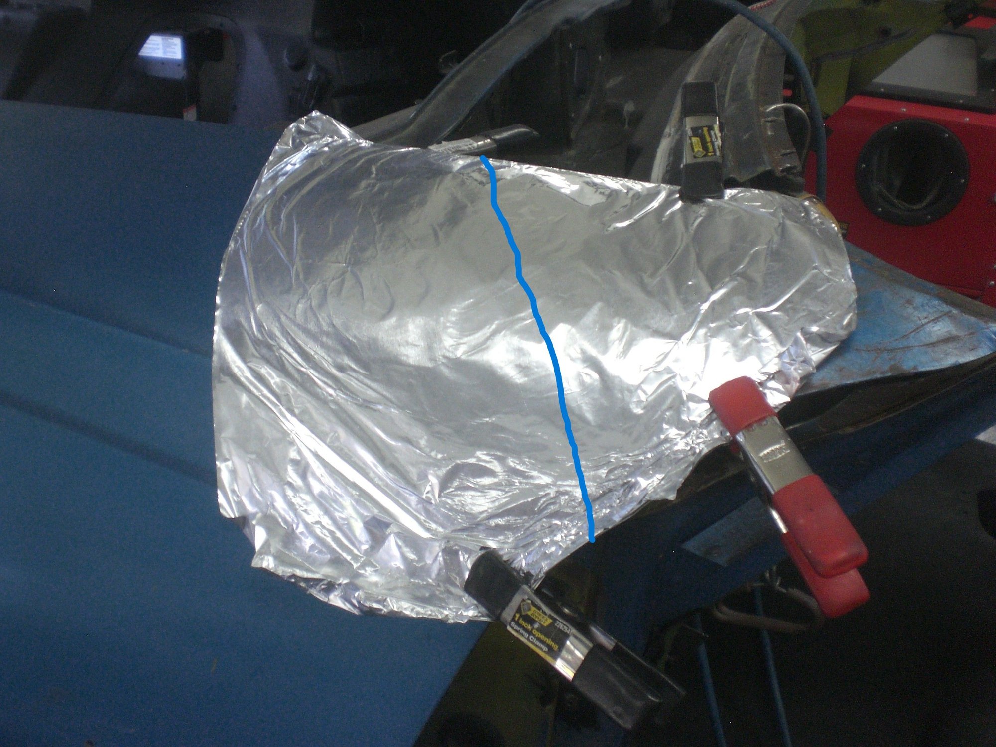 Fender covered with foil to prevent fiberglass resin from sticking to it