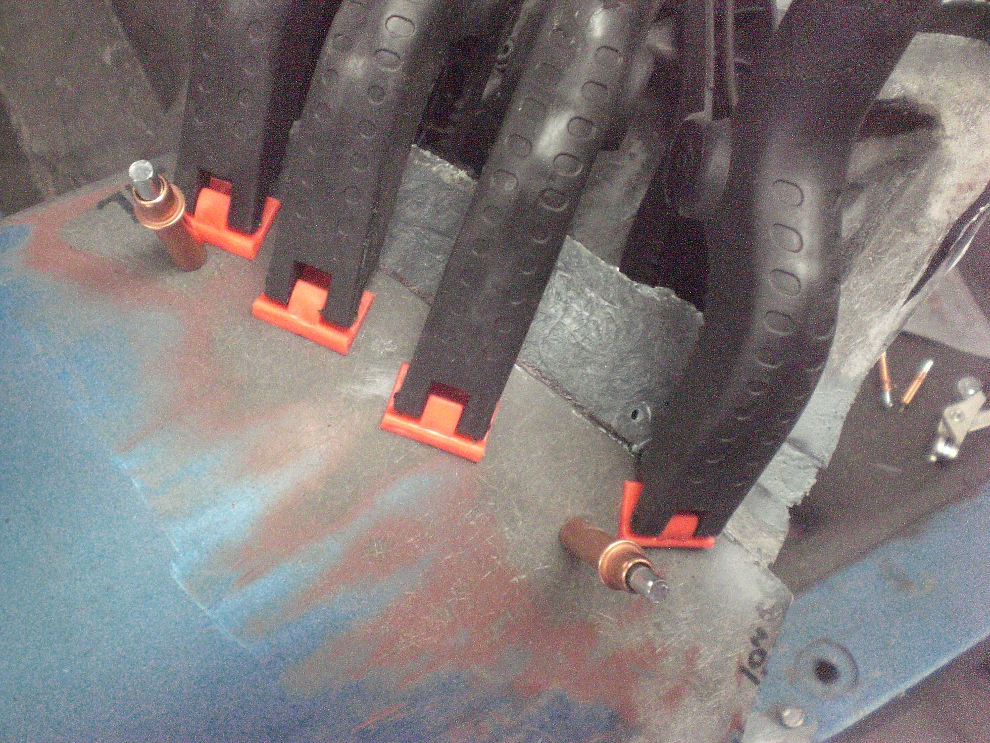 Glue was applied to half of the fender cut bonding strip which was then clecod into position then clamped.