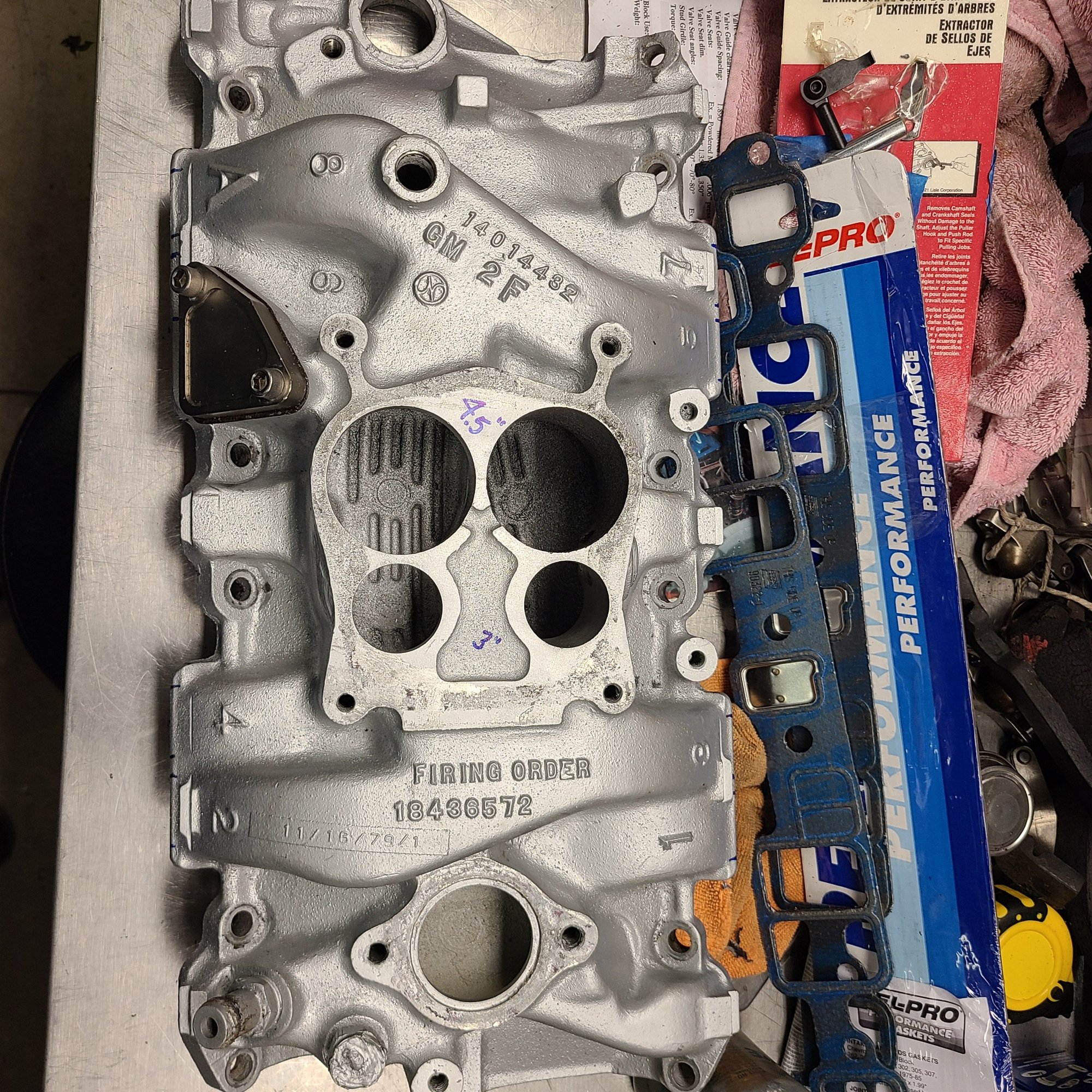 Stock GM L-82 aluminum intake measurements taken front and back from china wall surfaces to carb pad.