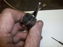 Insert your tool on the outside of the contact (lug) and push down as you push the wire up.  Can be tough to do with only 2 hands. You can feel when the tool slides past the tab on the lug.