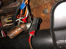 The switch is left of the two white wires