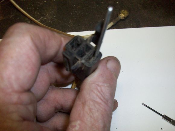 Insert your tool on the outside of the contact (lug) and push down as you push the wire up.  Can be tough to do with only 2 hands. You can feel when the tool slides past the tab on the lug.