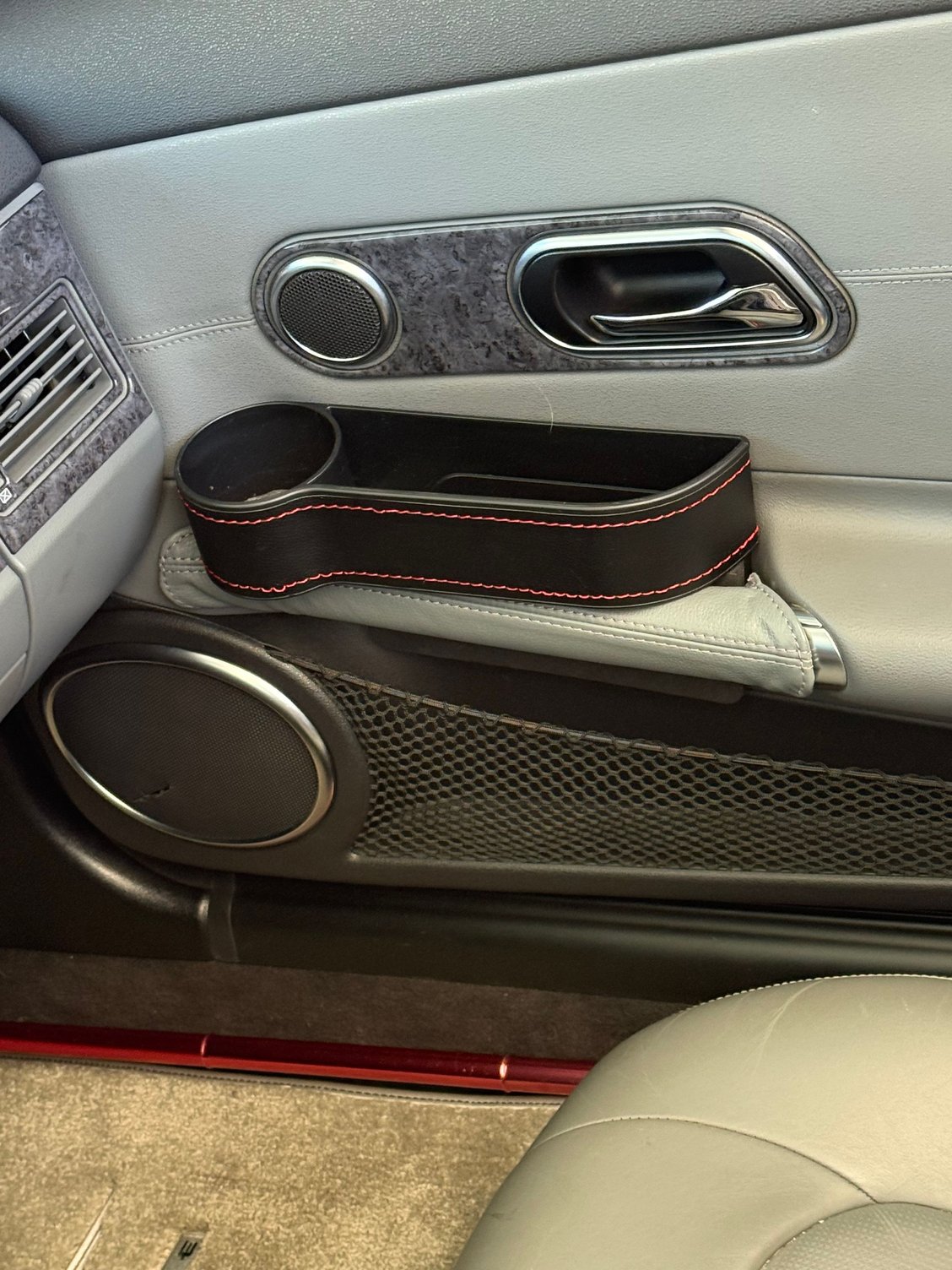 Cup holder, passenger side, includes slot for phones, etc.