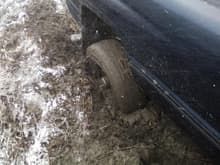 Rear tire sunk into the mud