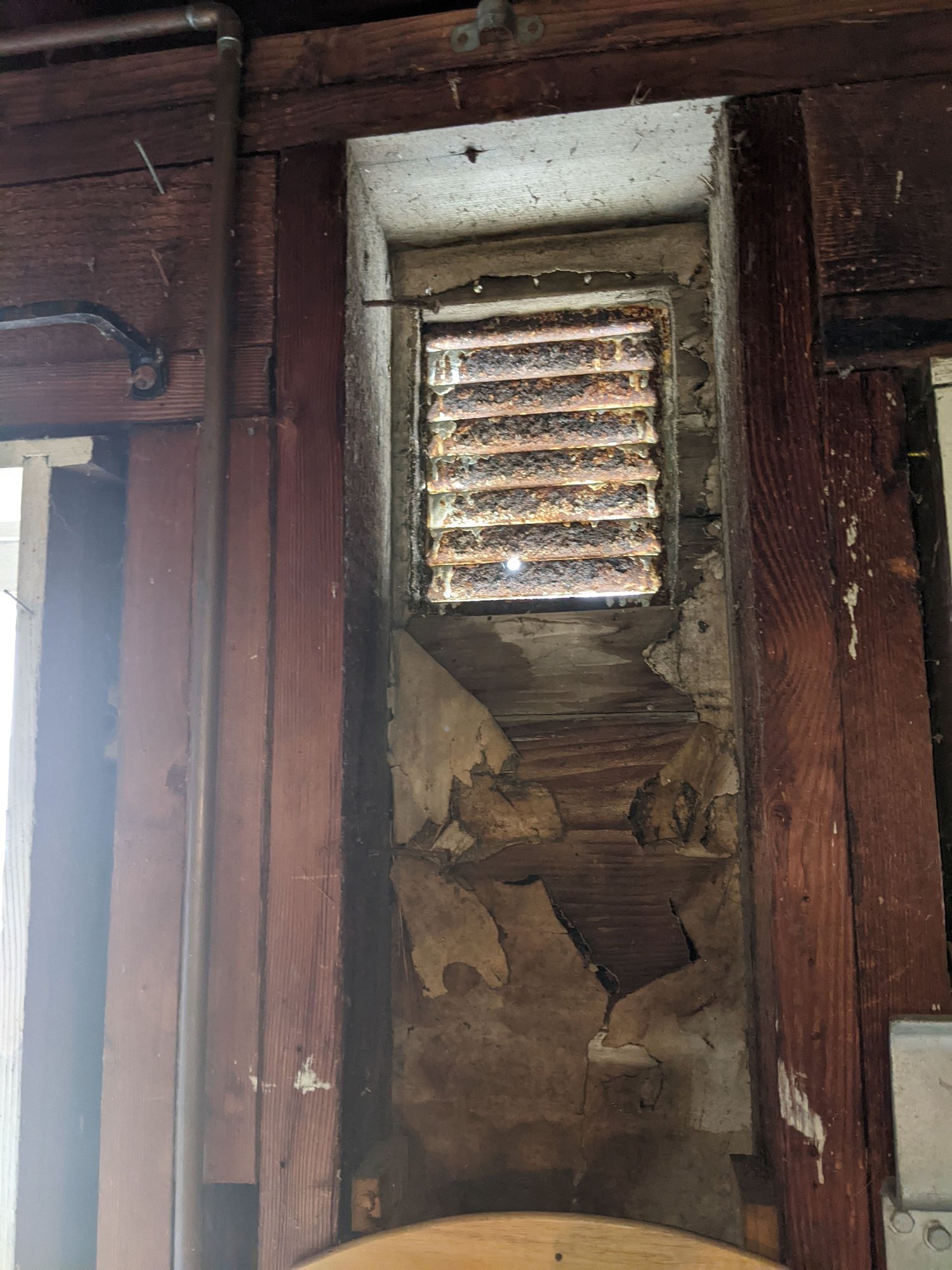 Old garage vapor barrier (felt paper?) peeling, is it safe to rip out