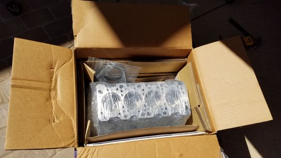 Cutting open the box for the first time. That loose part is my rear main seal housing.  They cleaned that up as well.