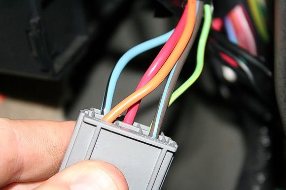 Step 7: Locate the connector on the back (towards the a pillar) of the fuse box with the orange, red, green, blue, and black connectors. Disconnect this connector and locate the BLUE/BLACK 12 gauge wire.