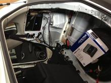 since interior space is tightly designed in the Fit, audio technician is custom fitting the AMP without sacrificing any usable space.
