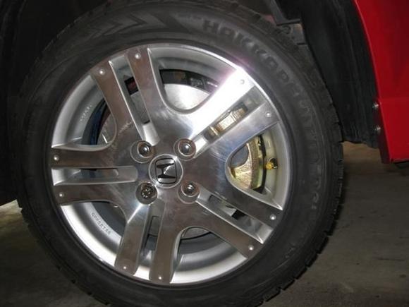 This is what it looks like under the stock 15" Sport wheel. Same problem here. The caliper just touches the inside of the wheel. Need the 3-mm spacers and longer studs...sigh!