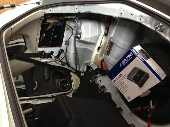 since interior space is tightly designed in the Fit, audio technician is custom fitting the AMP without sacrificing any usable space.