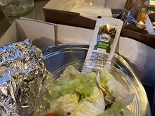 Foil-wrapped roll, salad, an iced tea, and a blonde brownie. 